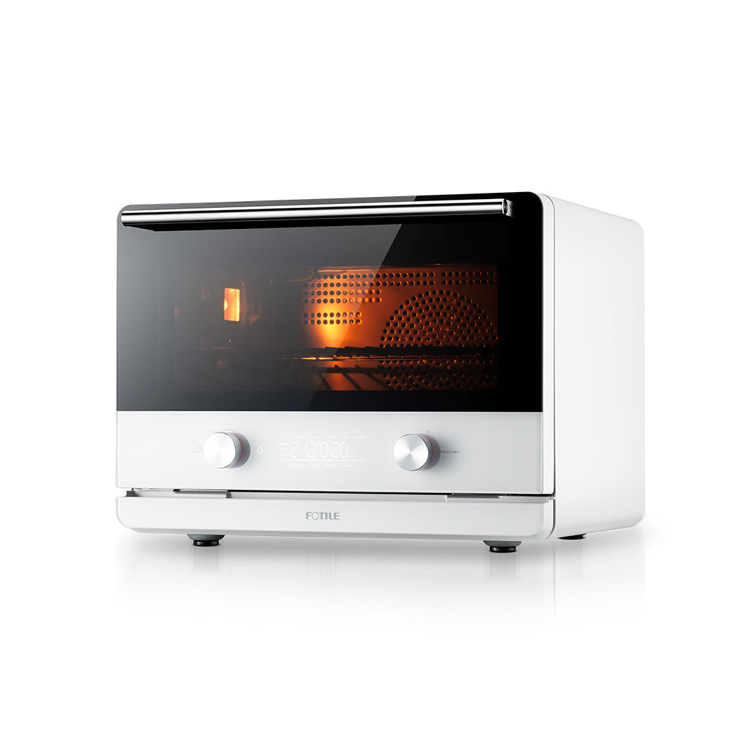 A sleek, white multifunctional countertop **Combi Steam Oven** with a black-tinted front door, two control knobs, and a digital display panel beneath them. The oven is turned on, showing an orange glow from inside. The word "**FOTILE**" is visible on the front near the bottom.